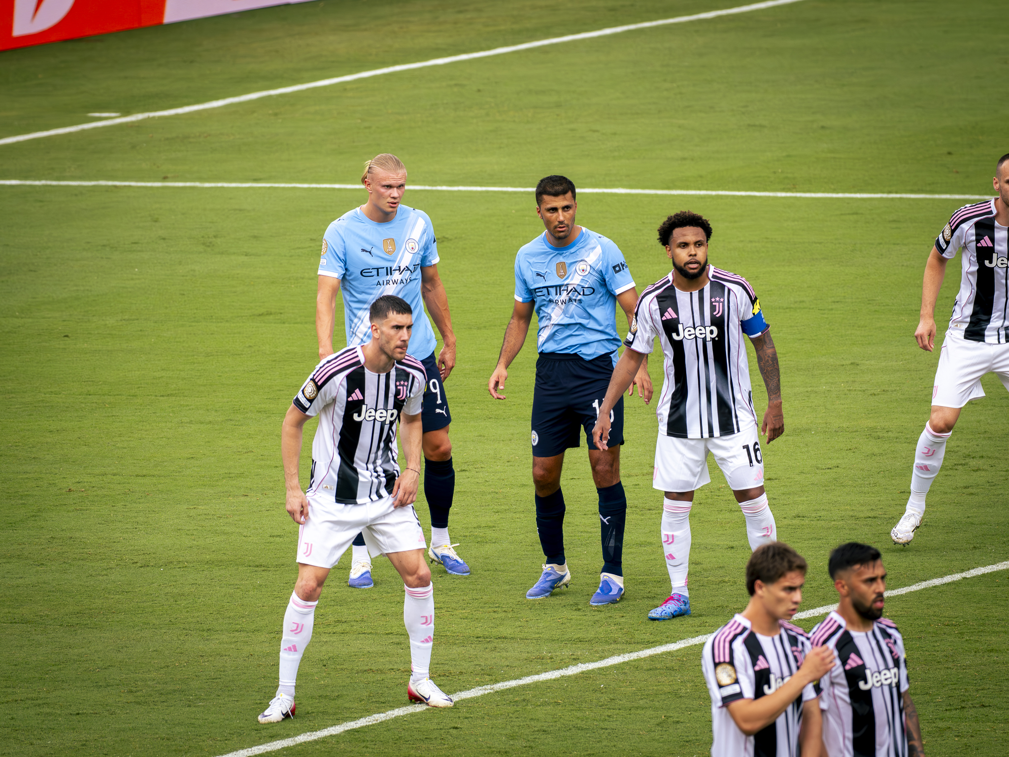Weston McKennie, Rodri and Erling Haaland await the ball