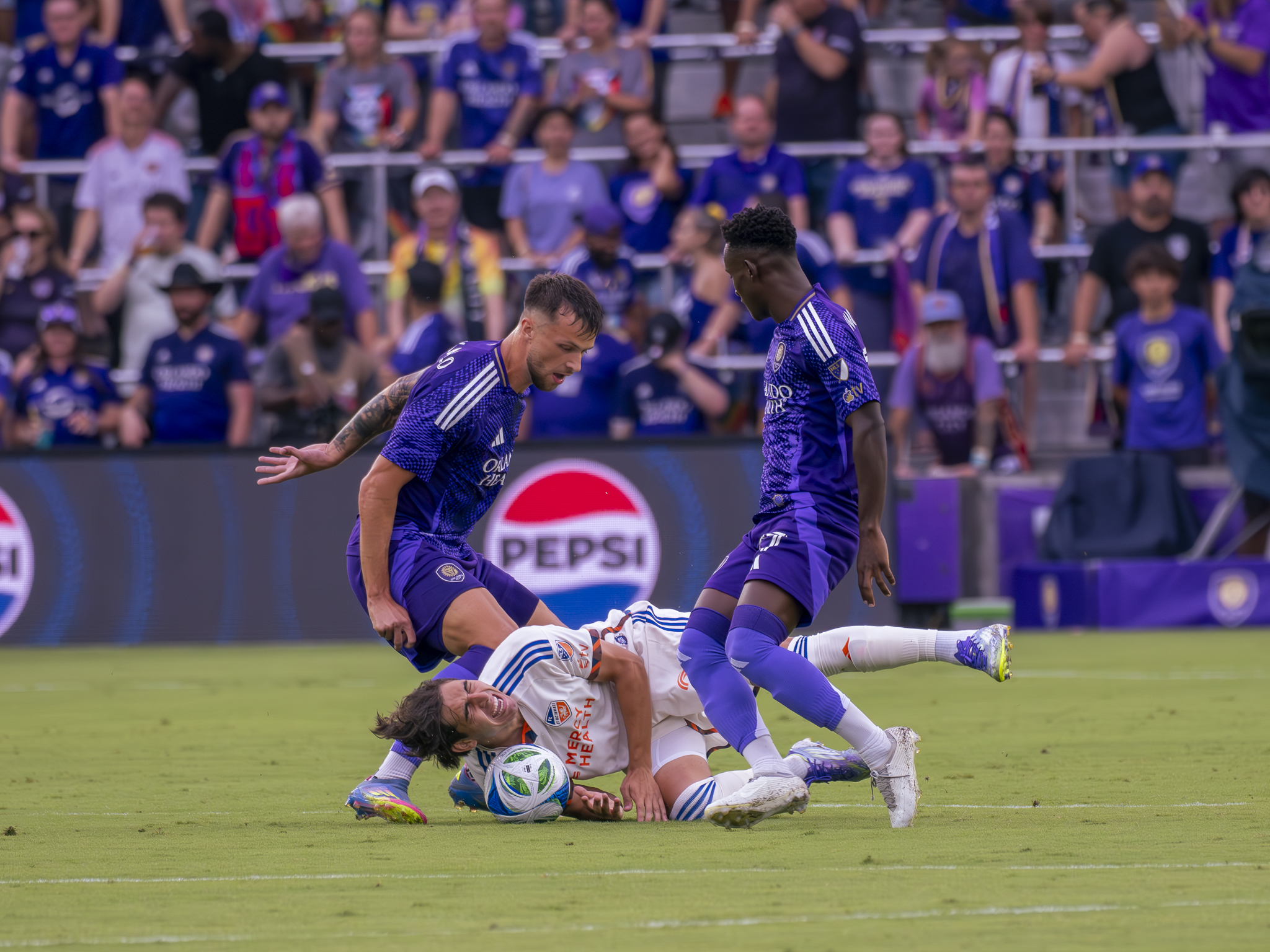 Dado Valenzuela gets fouled by two Orlando City players